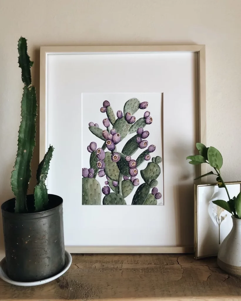 Photo of Prickly Pear Cactus with Blue Color Fruits and other Plants in Black and White Color Pot