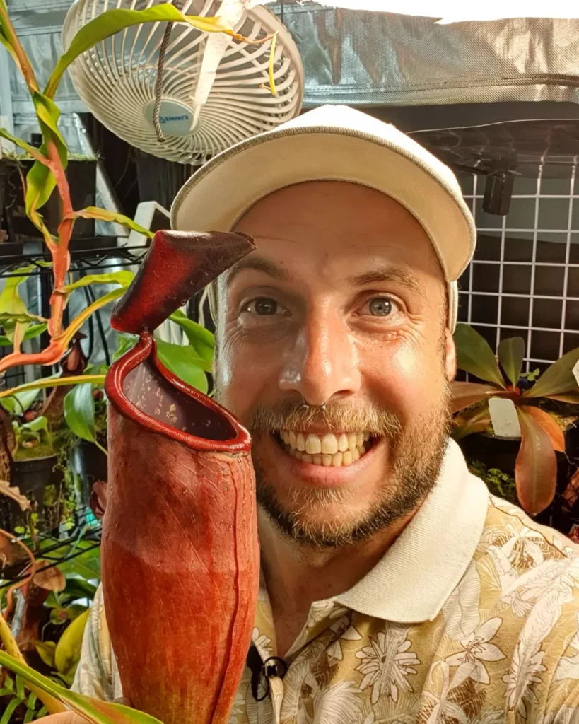 Happy Man Taking Photo with Brown Color Pitcher of Spotted Pitcher Plant (Nepenthes sanguinea) at Garden Area